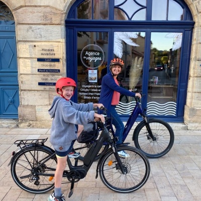 Véronique et son fils devant notre agence de voyage avec leur vélo pour la semaine